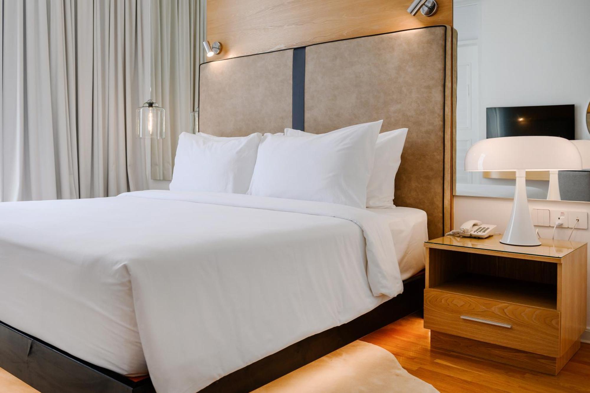 The Riyaz Lavanya Langkawi Pantai Cenang  Kültér fotó A bed with a nightstand